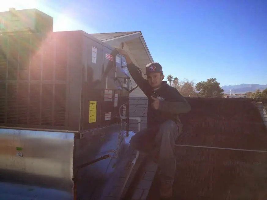 HVAC technician performing HVAC Inspection on a rooftop unit in Canal Fulton